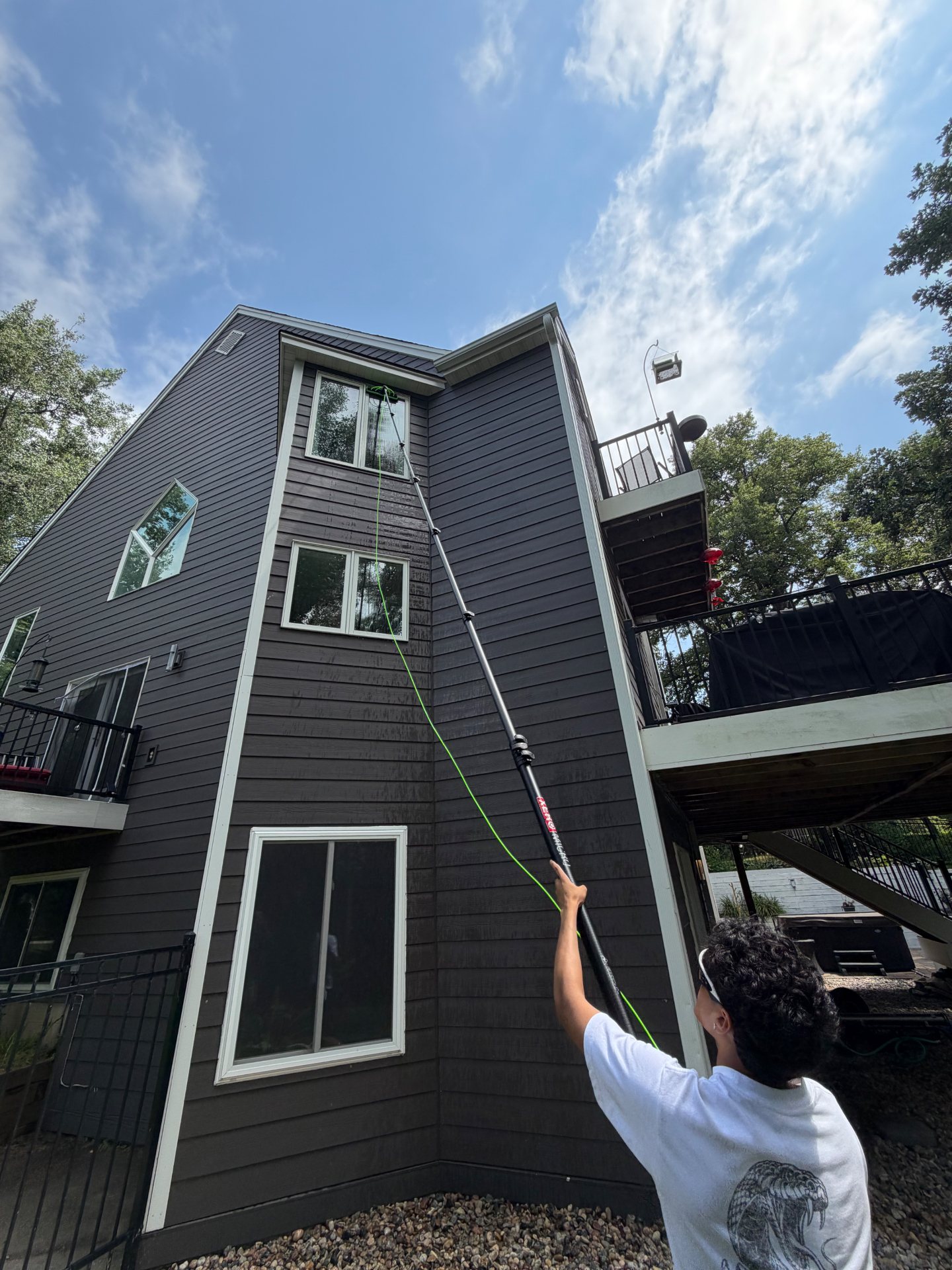 ClearWinz technician cleaning residential windows